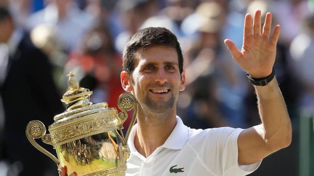 Novak Djokovic lifts the Wimbledon Men's Singles trophy in 2018