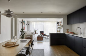 Period home renovation in South West London with a black handleless kitchen, oak floors and a light-filled living area in the rear extension